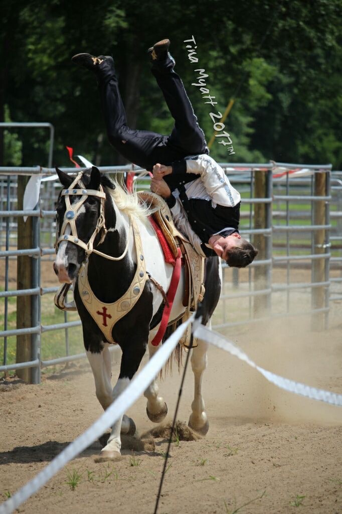 picture of cy doing a flip on a horse
